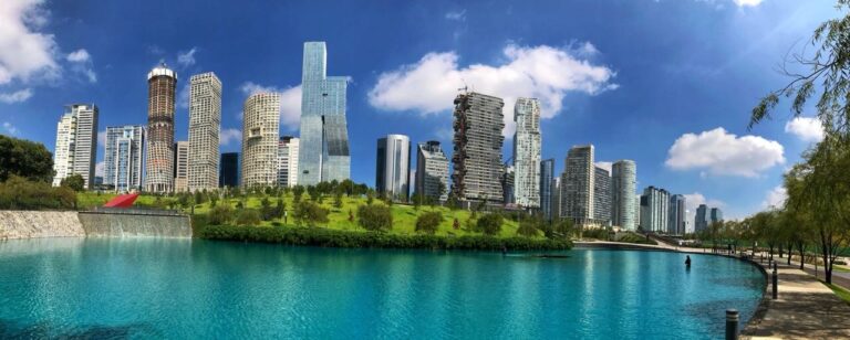 Mexico city tour lake and park and tallest building at the back in blue sky